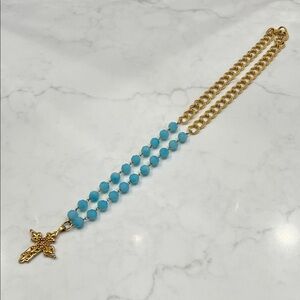 Gold tone cross with blue faceted beads and gold tone chain SS hallmark.